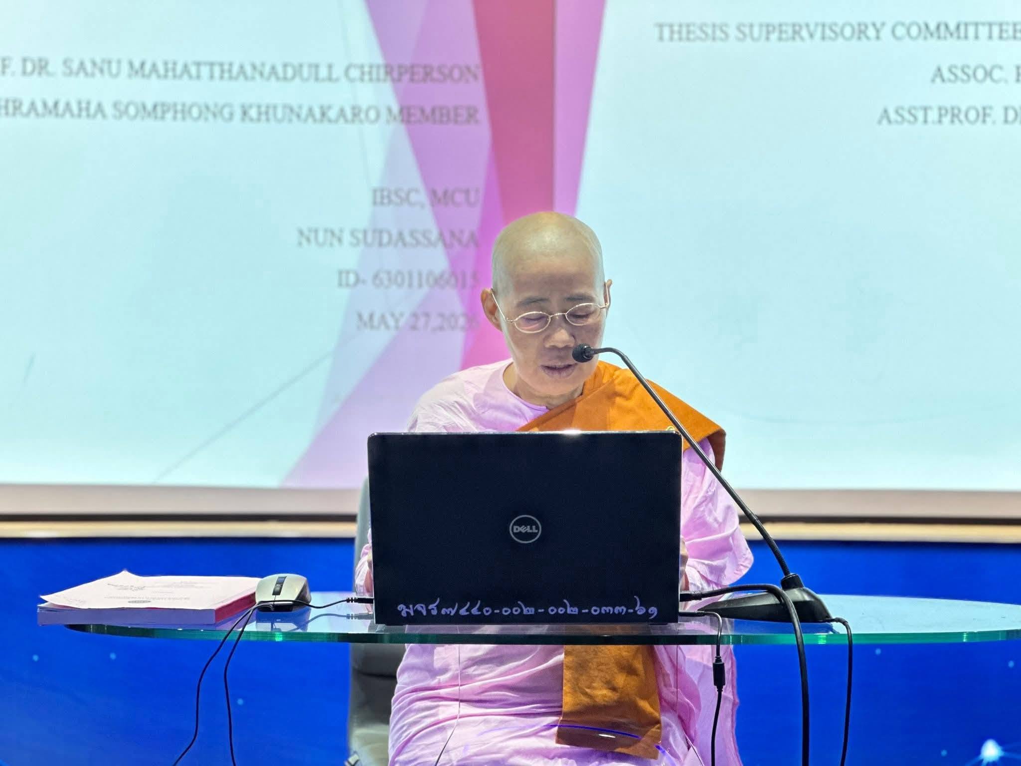 Dr. Sudassana speaking at an academic presentation